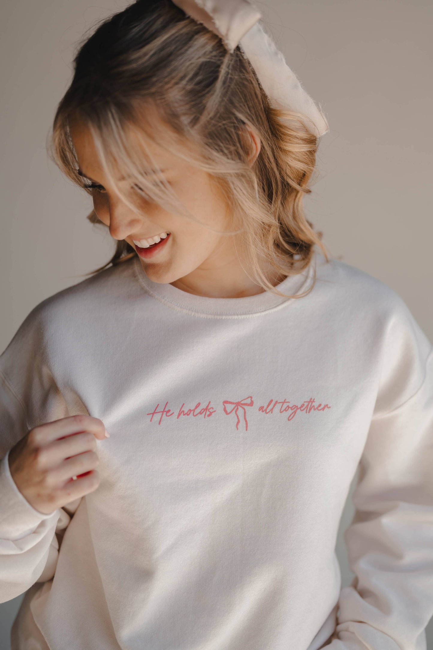 HE HOLDS IT ALL TOGETHER GRAPHIC SWEATSHIRT