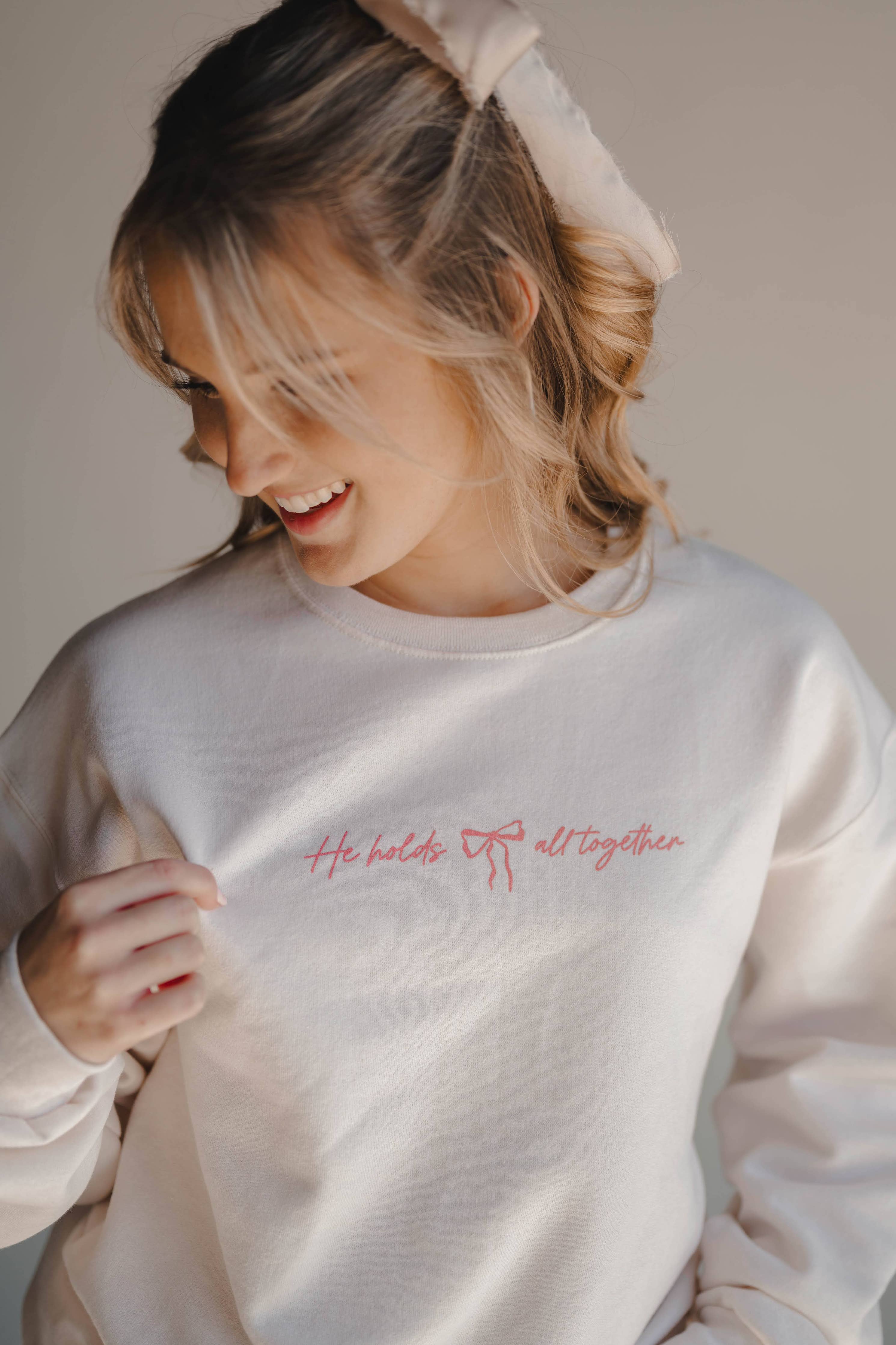 HE HOLDS IT ALL TOGETHER GRAPHIC SWEATSHIRT