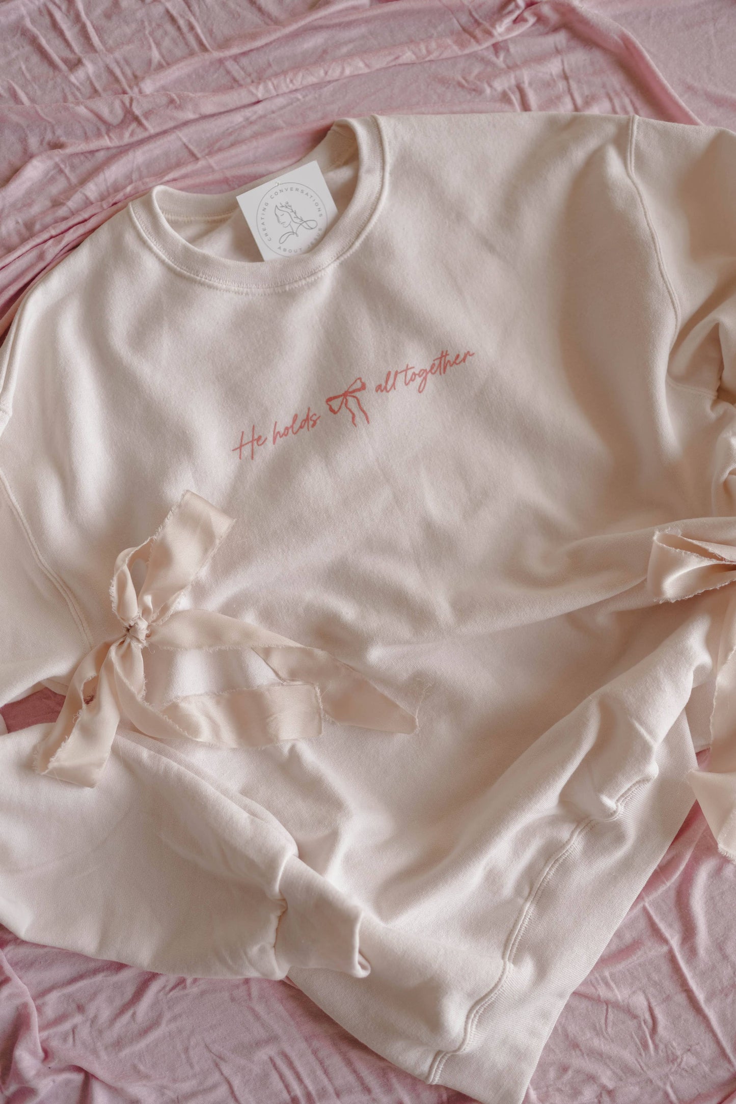 HE HOLDS IT ALL TOGETHER GRAPHIC SWEATSHIRT